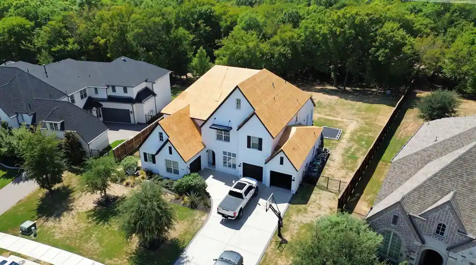 A roof going on, from bare wood deck to finished shingles